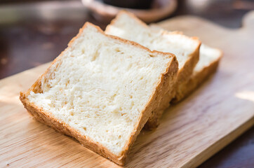 A slice of bread that sits on a wooden table.