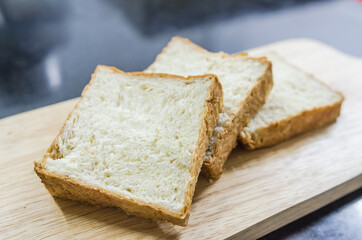 A slice of bread that sits on a wooden table.