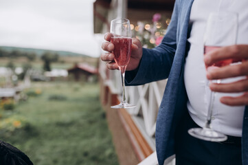 a man holds a glass of champagne in his hand