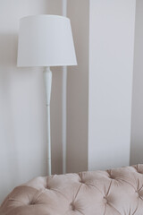 white floor lamp in a white hotel room