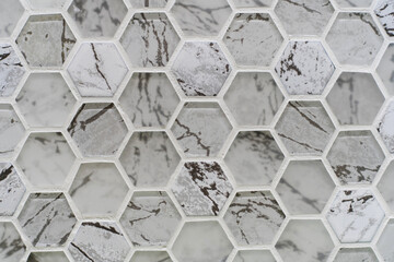 Hexagonal frosted glass and ceramic tiles. Sample wall cladding in the form of honeycombs. Flat lay of the frame. Small objects
