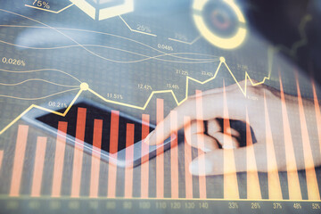 Double exposure of forex chart sketch hologram and woman holding and using a mobile device. Financial market concept.