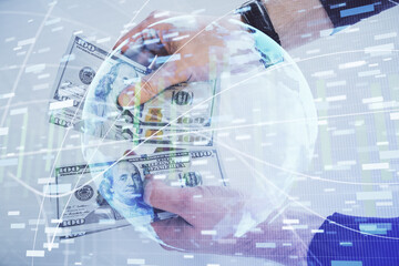 Multi exposure of financial theme drawing hologram and USA dollars bills and man hands. Business concept.