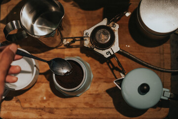 Top view of a man making coffee using mocca pot.Close up shot.Vintage filter effect and artificial...