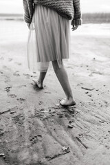 girl with beautiful walking barefoot on the beach
