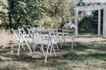 place for a wedding ceremony with white chairs
