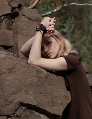 Beautiful girl in a dress on the rocks