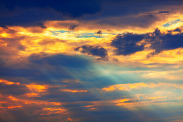 Naklejka na ściany i meble Sun rays in colorful clouds . Fantastic sky in the dusk 