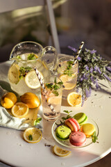 a romantic little table in a cafe in the sun, with lemonade and macaroon and lavender