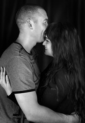 Black and white photoshoot of a couple in the studio