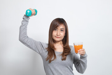Young Asian woman with dumbbell drink orange juice.
