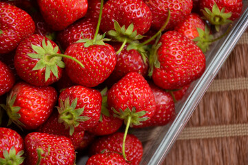 Strawberries in the glass bowl. Freshly picked strawberry. Organic sweet berries. Village garden harvest.