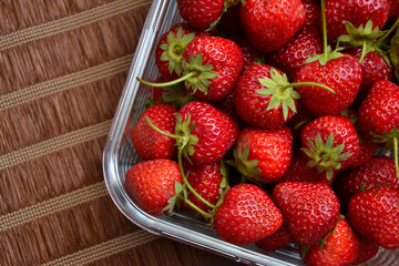 Strawberries in the glass bowl. Freshly picked strawberry. Organic sweet berries. Village garden harvest.
