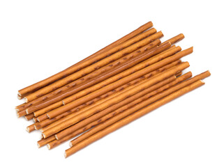Sweet straws. Dry baked goods in the form of thin sticks. White background.