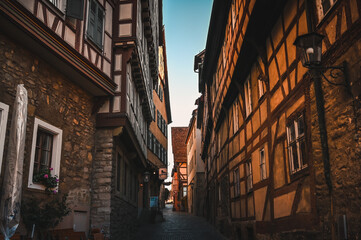 A narrow street leading between half-timbered houses in the old town of Schw&auml;bisch Hall, Germany.