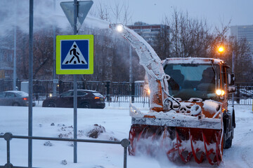 Snowblower works on the street of winter Moscow