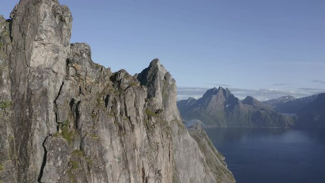 Incredible peak of Segla mountain diving into a beautiful Norwegian fjord