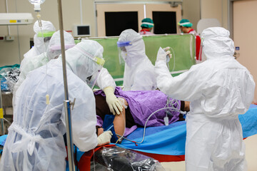 Medical team wear PPE suit moving coronavirus infected patient to treatment in hospital...