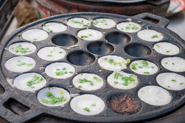Kanom Krok, a traditional Thai dessert made from crushed coconut meat.