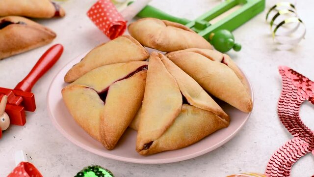 Purim celebration background. Jewish carnival. Traditional jewish hamantaschen cookies cakes and Purim masquerade accessories on light background