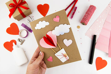 Valentine's Day. Instructions for making cards for Valentine's Day. Step 10 glue the hearts and clouds to the base. The postcard is ready.