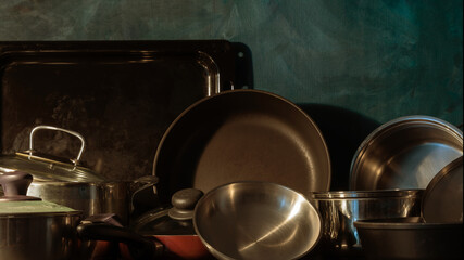Pots and pans stacked on a kitchen shelf