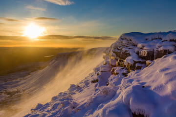 Beautiful sunrise over a cold., snow covered mountain