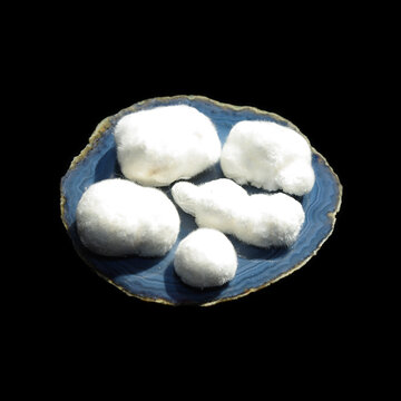 okenite on angelite on black background 