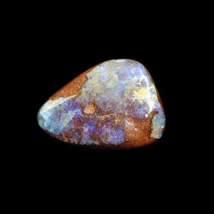 Tumbling opal stone on black background 