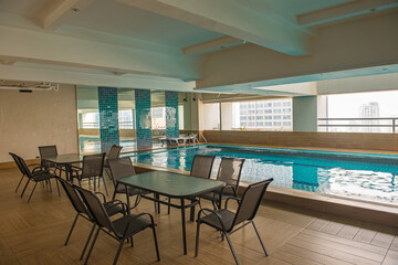 Empty swimming pool area at modern condominium building