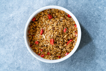 Oven Baked Artisan Granola with Dried Strawberries and Chia Seeds in Bowl.