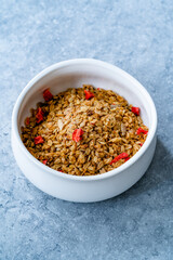 Oven Baked Artisan Granola with Dried Strawberries and Chia Seeds in Bowl.