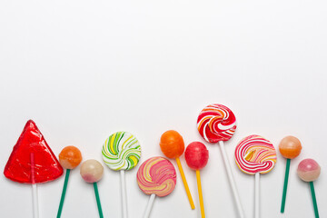Various types of lollipops on white background