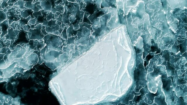 Aerial shot of abstract ice surface frozen blue sea. Drone top down. 4k
