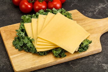 Sliced Gauda cheese over board