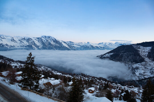 The swiss alps village of La Tzoumaz, Valais, Switzerland, with a sea of clouds covering the valley down below.