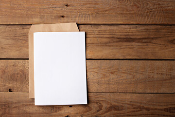 Blank white paper page on wooden table