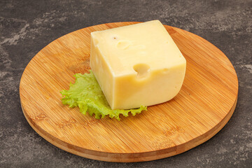Emmental cheese over wooden board