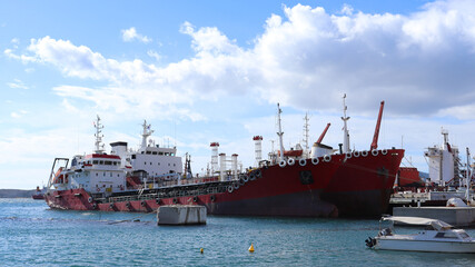 Industrial port of Keratsini with anchored tug boats and crane machinery, Piraeus, Attica, Greece