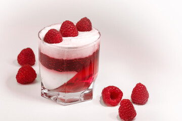 White delicious yogurt dessert with raspberry berries, jam and raspberry jelly. Healthy Breakfast, light snack. The concept of healthy eating.