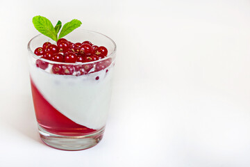 White delicious yogurt dessert with red currant berries and raspberry jelly. Healthy Breakfast, light snack. The concept of healthy eating.