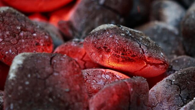 Glowing Charcoal Briquettes, BBQ oder close up of coals burning

