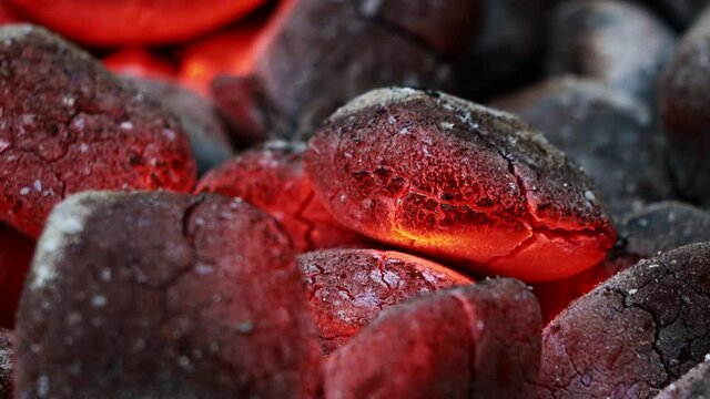 Glowing Charcoal Briquettes, BBQ oder close up of coals burning
