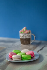 Plate of colored macaroons and a cup