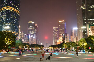 Guangzhou central street and skyscrapers during foggy evening, China