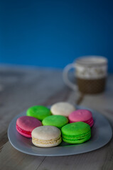 Plate of colored macaroons and a cup