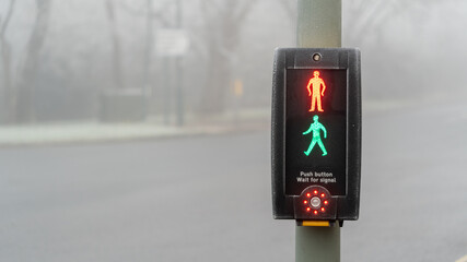 UK traffic crossing with All lights Illuminated on a cold foggy day	
