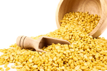 peeled split mung bean in wooden scoop isolated on white background.Ingredients for cooking Healthy and Natural Food concept