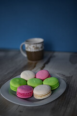 Plate of colored macaroons and a cup