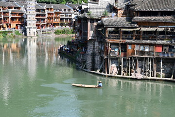 Fishing boat on the river in ancient city of Feng Huang, China